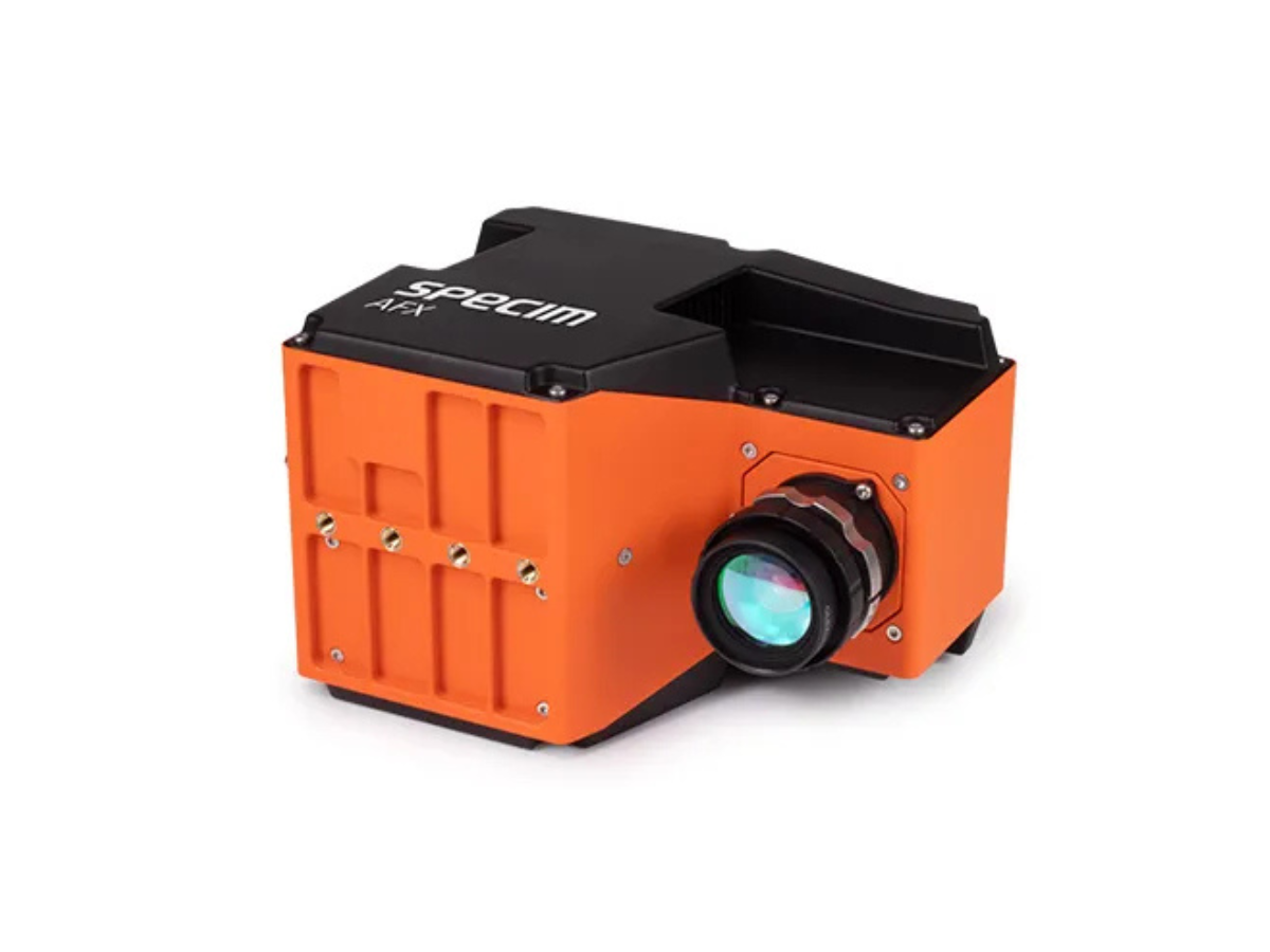 Specim AFX17 hyperspectral imaging system for airborne use, sitting on side with objective lens mounted.