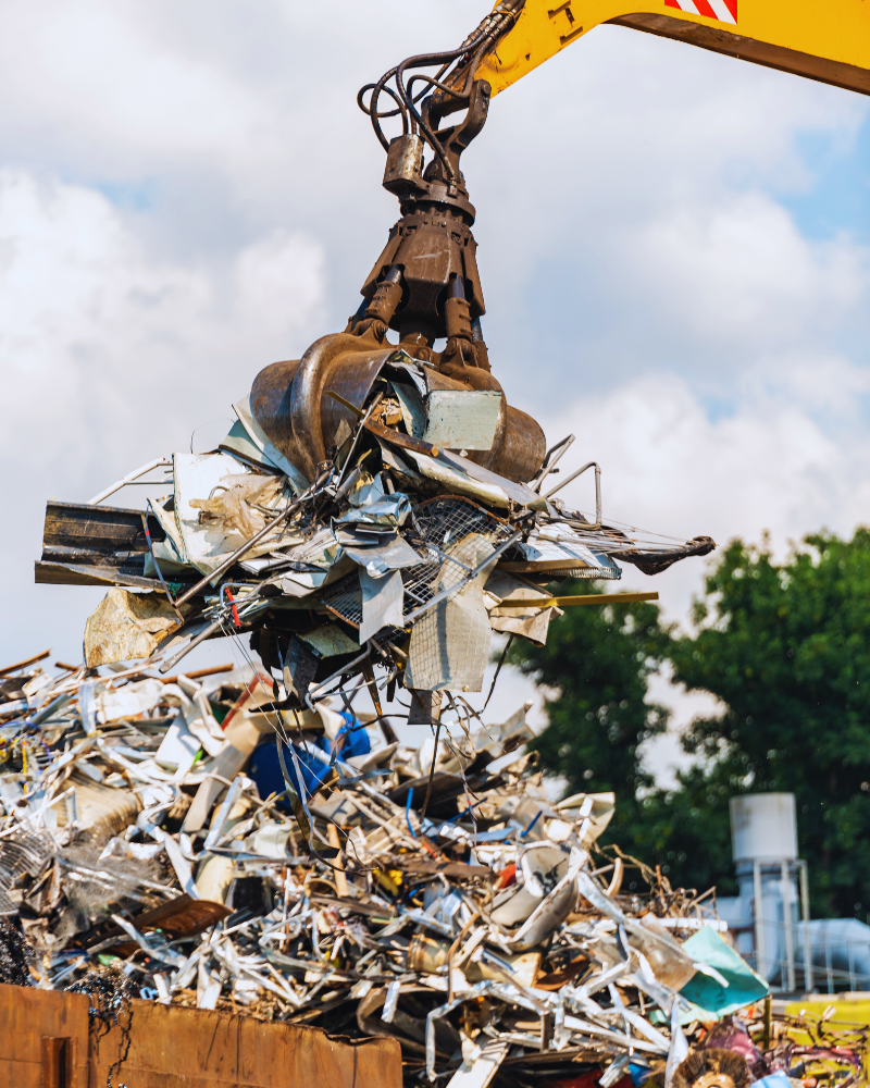 Construction waste being piled by heavy machinery