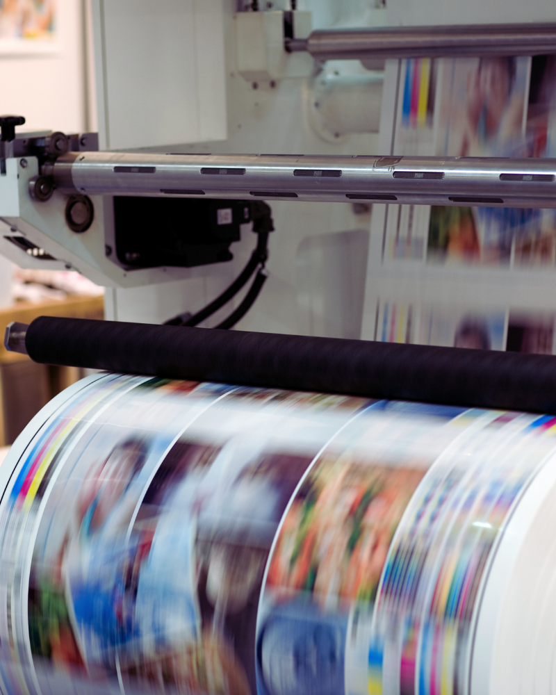 Industrial printer printing coloured paper products